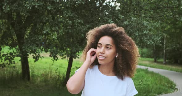 Laughing Mixed Race Lady Dancing Listen Favorite Music in Earphones Walking at Summer Forest Park alt