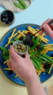 Vertical Tabletop Video Chef Adds Capers to the Fried Potato Dish