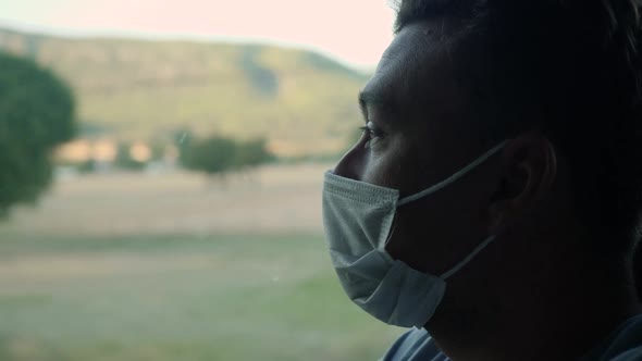 Man Looks Out Window alt