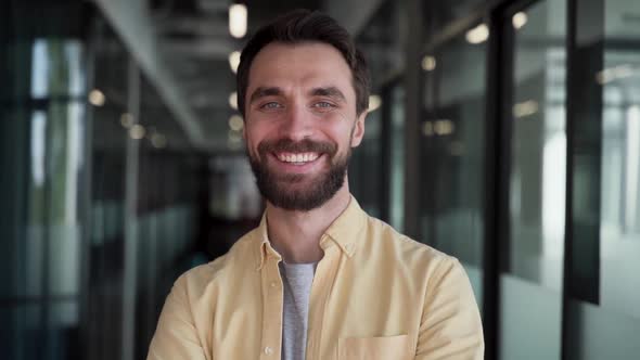 Confident caucasian bearded businessman smiling cheery to the camera alt