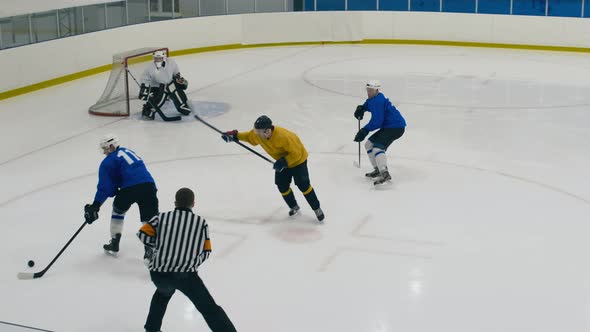 Hockey players fighting for puck and shooting goal