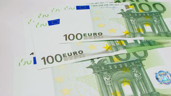 Recalculation of money. Hands count European Euro bills on white background. One hundred Euro