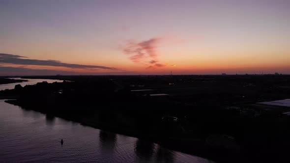 Colorful Sky At Sunset Over Silhouetted Town Of Barendrecht During Summer In South Holland, Netherla alt