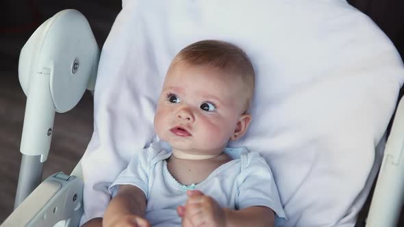 Cute Little Newborn Girl with Smiling Face Looking at Camera on White Background alt