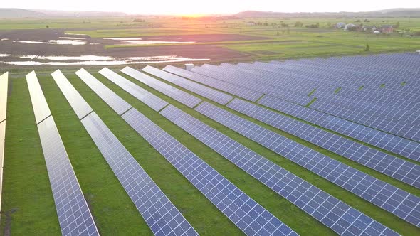 Aerial view of green field with solar energy panels for renewable electricity production. alt