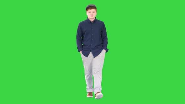 Fashionable Young Man Walking with Hands in Pockets on a Green Screen, Chroma Key alt
