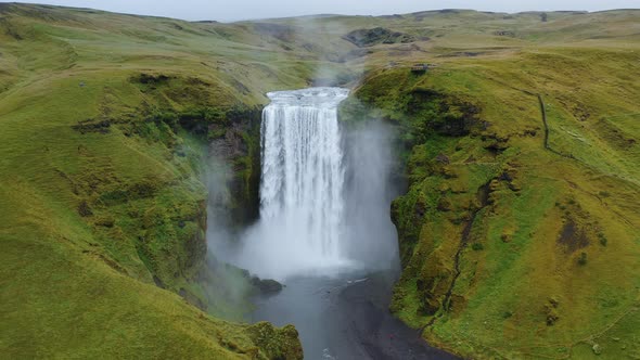 Aerial Circle Fly Above Skogafoss Waterfall on Skoga River on South Iceland in Summer alt