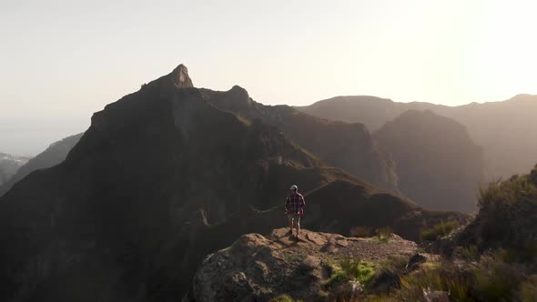Man Walking to the Edge of a Cliff in the Mountains of Madeira Island