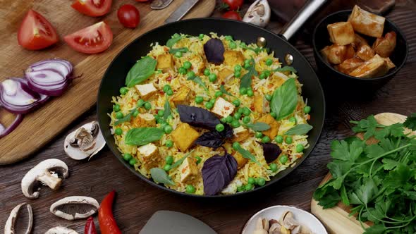 Vegetable Rice with Green Peas Carrots Tofu and Mushrooms on Wooden Background alt