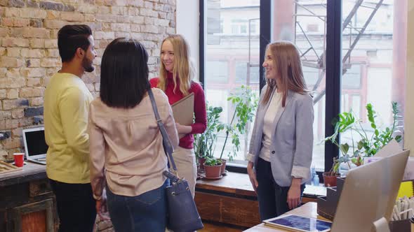 Customers Shaking Hands with Female Designers and Leaving Studio