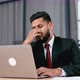 Tired Exhausted Indian or Arabian Businessman in a Suit Sit at Workplace in Office Rubbing His Nose - VideoHive Item for Sale
