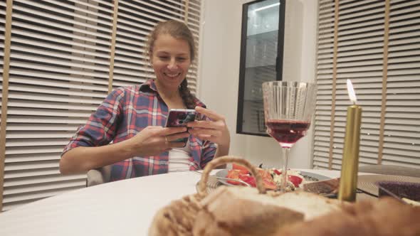 Couple Using Cellphone On Dinner