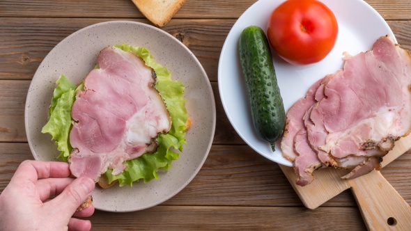 Making and Eating Sandwich with Tomato, Ham, Cheese and Salad