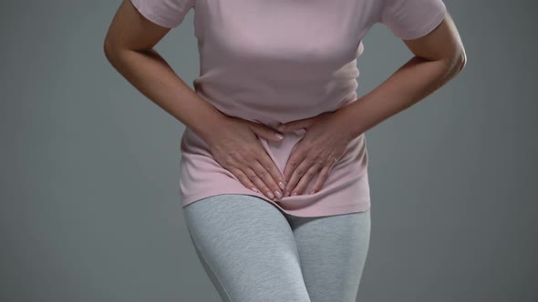 Woman Writhing From Pain in Lower Abdomen, Menstrual Pain, Risk of Miscarriage