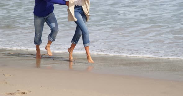 Mature couple enjoying on beach alt