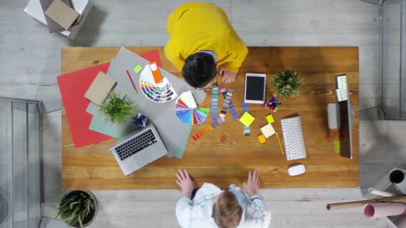 Two Male Designers Giving High Five alt