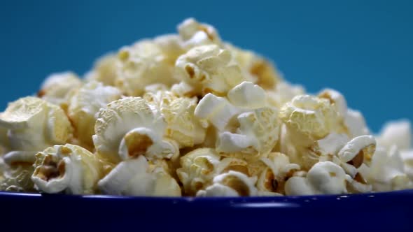 Cooked Popcorn in a Plate on a Blue Background