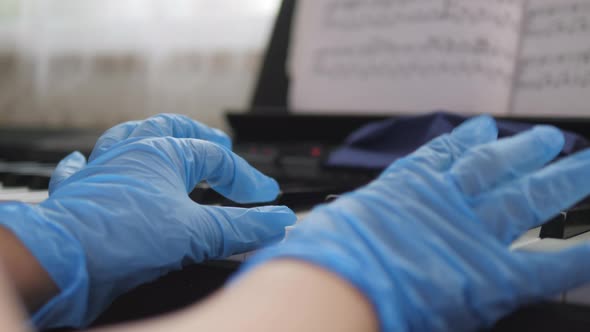 Electronic Piano. Fingers Press the Piano Keys. Hands in Rubber Gloves. Pandemic 2020, Self alt