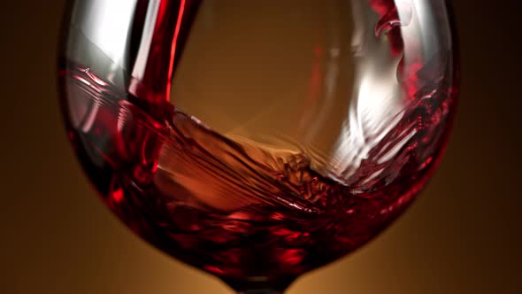 Super Slow Motion Detail Shot of Pouring Red Wine on Luxury Gradient Background at 1000Fps alt
