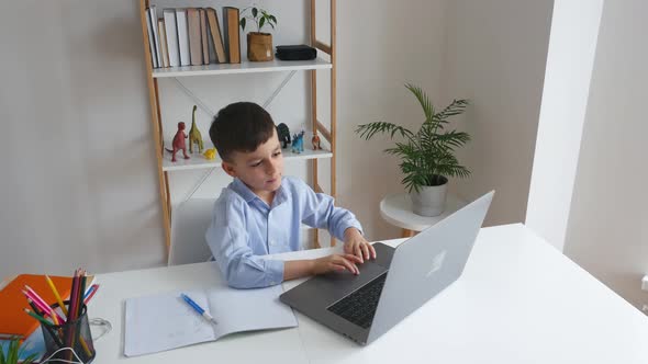 Kid Via Laptop Talking with Teacher During Online Studying at Home