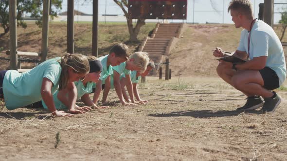 Group of Caucasian children training at boot camp alt
