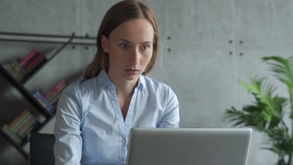Excited Business Woman Celebrates Success in the Workplace alt