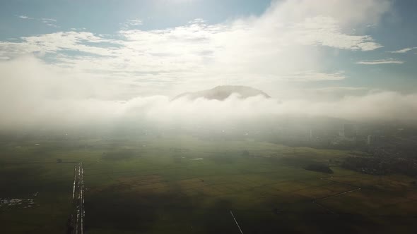 Aerial white cloud moving in morning over the mountain and green paddy fieldsia. alt