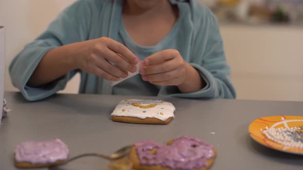 Girl Decorates Homemade Gingerbread for Easter