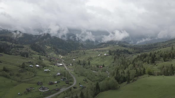 Ukraine, Carpathian Mountains: Village in the Mountains. Aerial, Flat, Gray alt