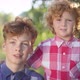 Redhead Caucasian Little and Teenage Brothers Posing on Sunny Day in Spring Summer Park - VideoHive Item for Sale
