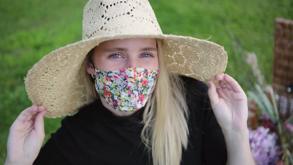 Fashionable girl wearing face mask flirting with camera at the park alt