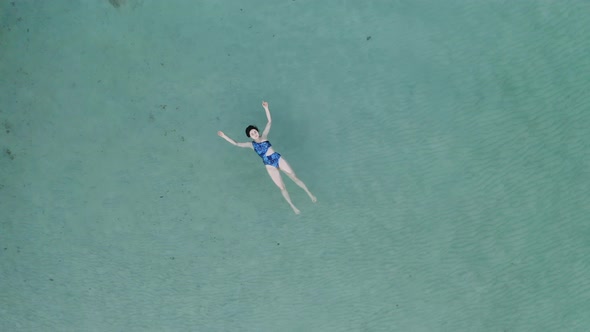 Aerial view of Beautiful young woman swimming