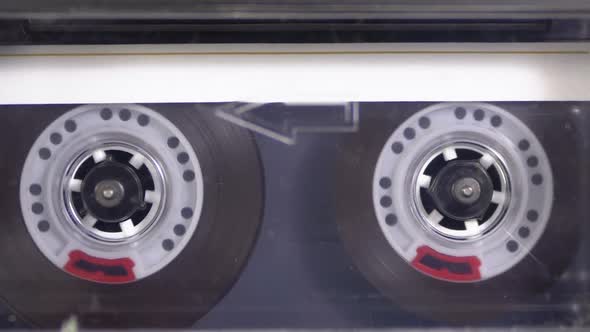 Audio Cassette Is Inserted Into the Deck of the Audio Tape Recorder Playing and Rotates alt