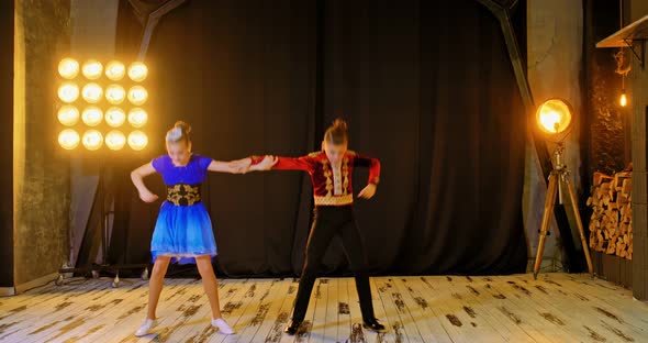 Guy with the Girl Dancing a Sport Dance in the Hall, Bright Light, Dancing Couple Makes Effective alt