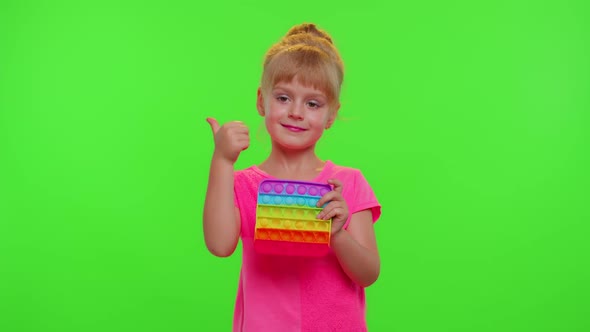 Child Girl Playing Squishy Silicone Bubbles Sensory Toy Simple Dimple Pop It Game Chroma Key alt