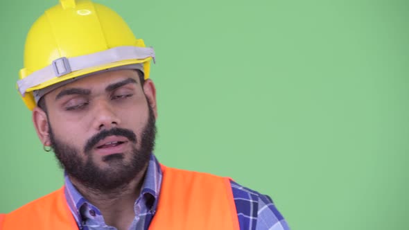 Face of Serious Young Overweight Bearded Indian Man Construction Worker Nodding Head No alt