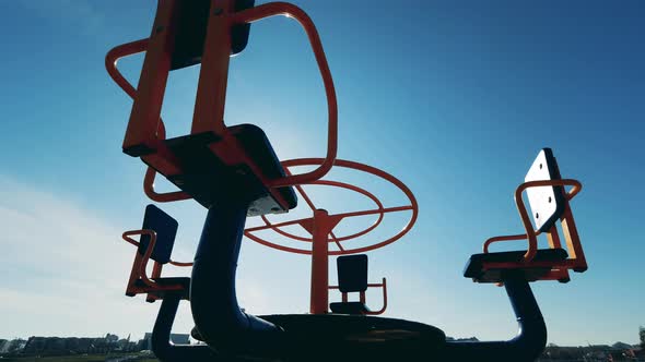 Empty Children's Carousel Is Revolving in Sunlight. Coronavirus, Covid-19 Lockdown. alt