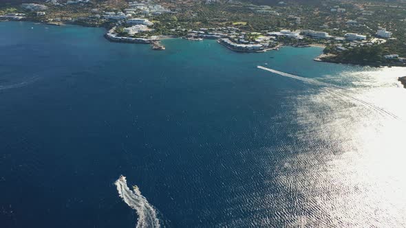 Aerial View of a Motor Boat Towing a Tube. Elounda, Crete, Greece