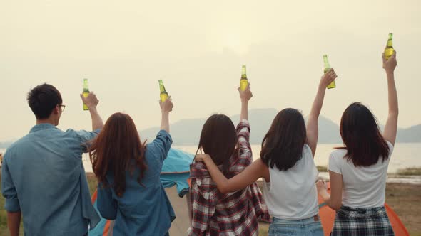 Group of Asia best friends teenagers salute and cheers toast of bottle  beer enjoy party with happy.
