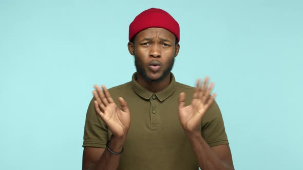 Slow Motion of Handsome African American Man in Red Beanie Saying No Shaking Head and Hands to