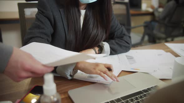 An Adult Lady is Working in a Protective Mask alt