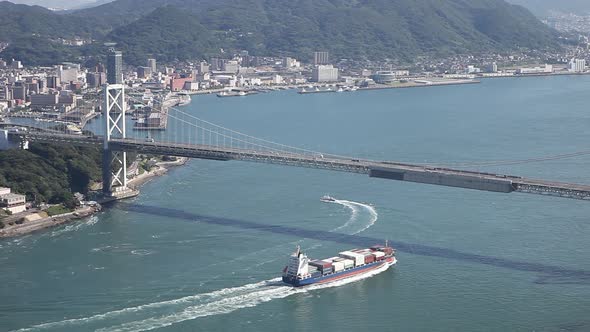 Container Ship Sailing under Big Bridge alt