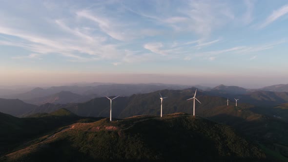 Wind Turbines in mountain during sunset alt