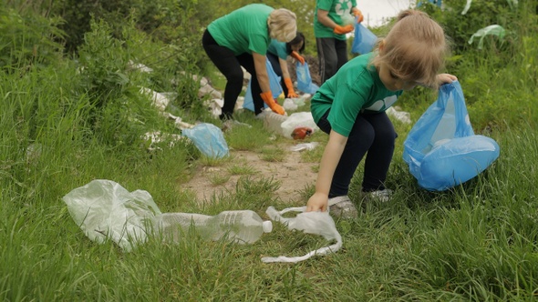 Volunteer Team Cleaning Up Dirty Park From Plastic Bags, Bottles. Reduce Trash Cellophane Pollution alt