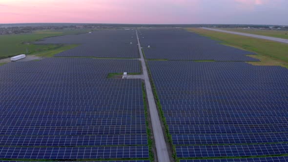 Drone Fly Over Solar Farm. Renewable Green Energy and Electrical Technology. Field of Solar Panels alt