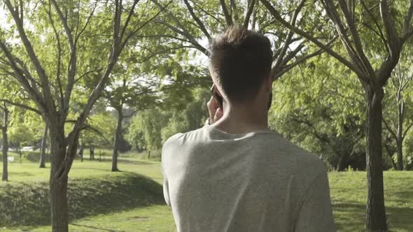 Young man talking on smartphone alt