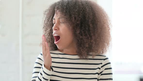 Exhausted African Woman Yawning  alt
