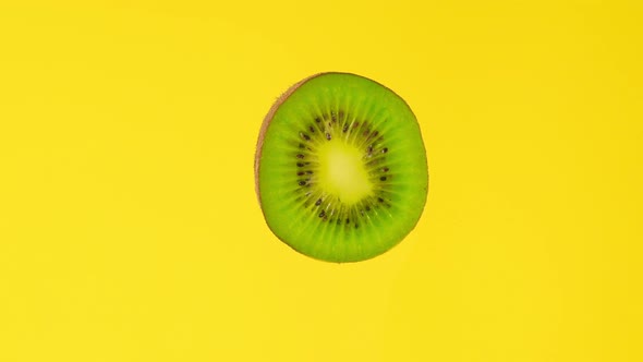 Kiwi Slice Rotating Front View on Yellow Background