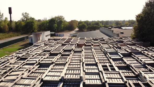Warehouses. Stacks of Wooden Crates for Fruit, Large Boxes for Apples Stand Outdoors, on Warehouse alt