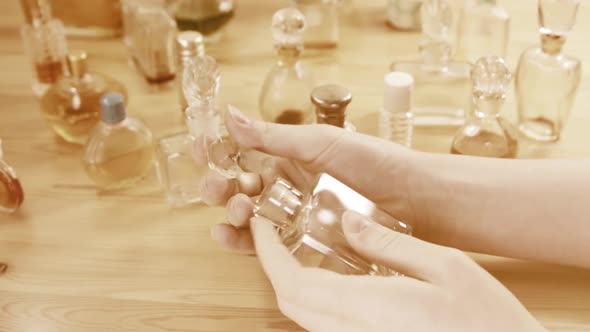 Vintage perfumes bottles In Hands Of A Girl